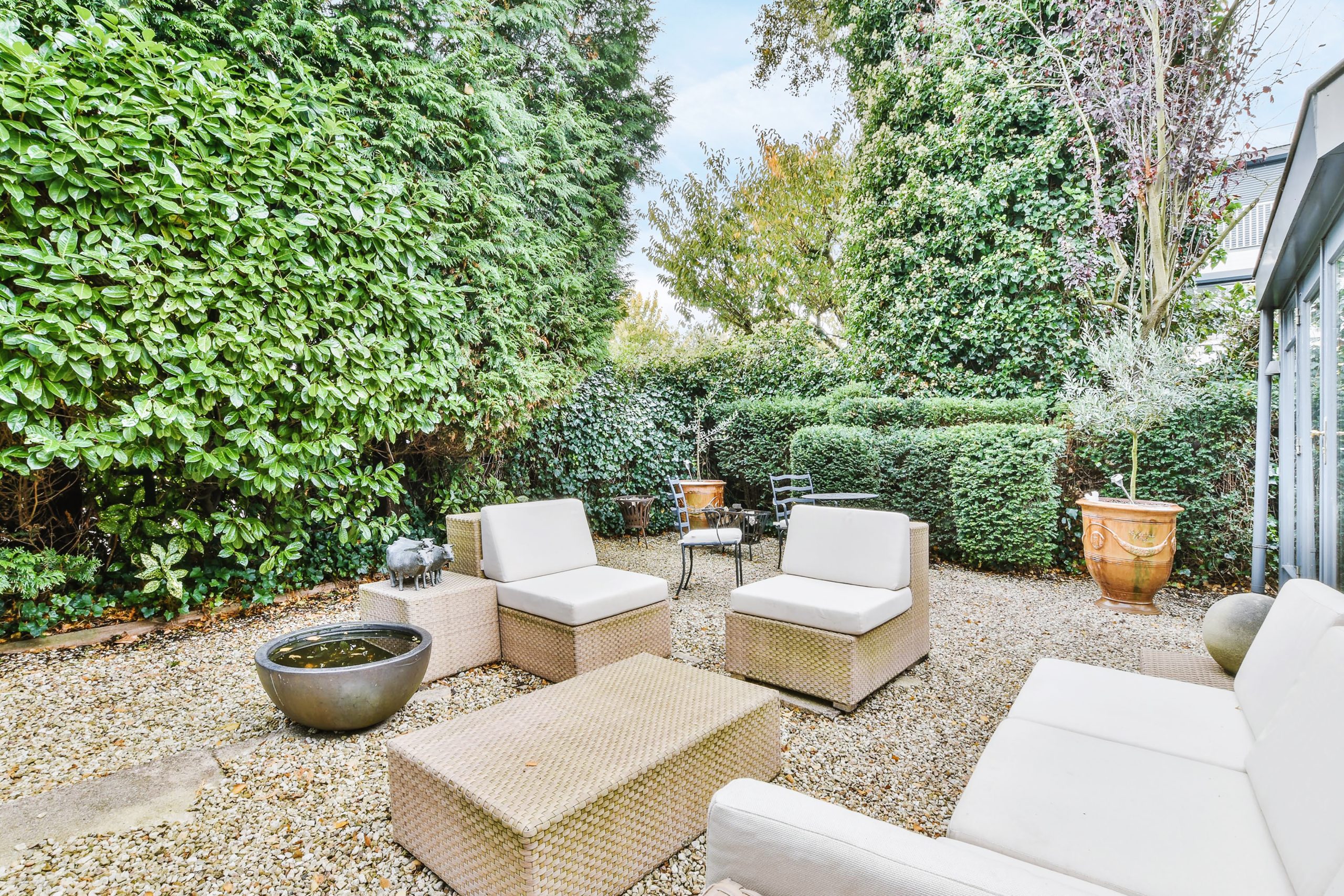 Beautiful backyard terrace full of furniture and decorative plants
