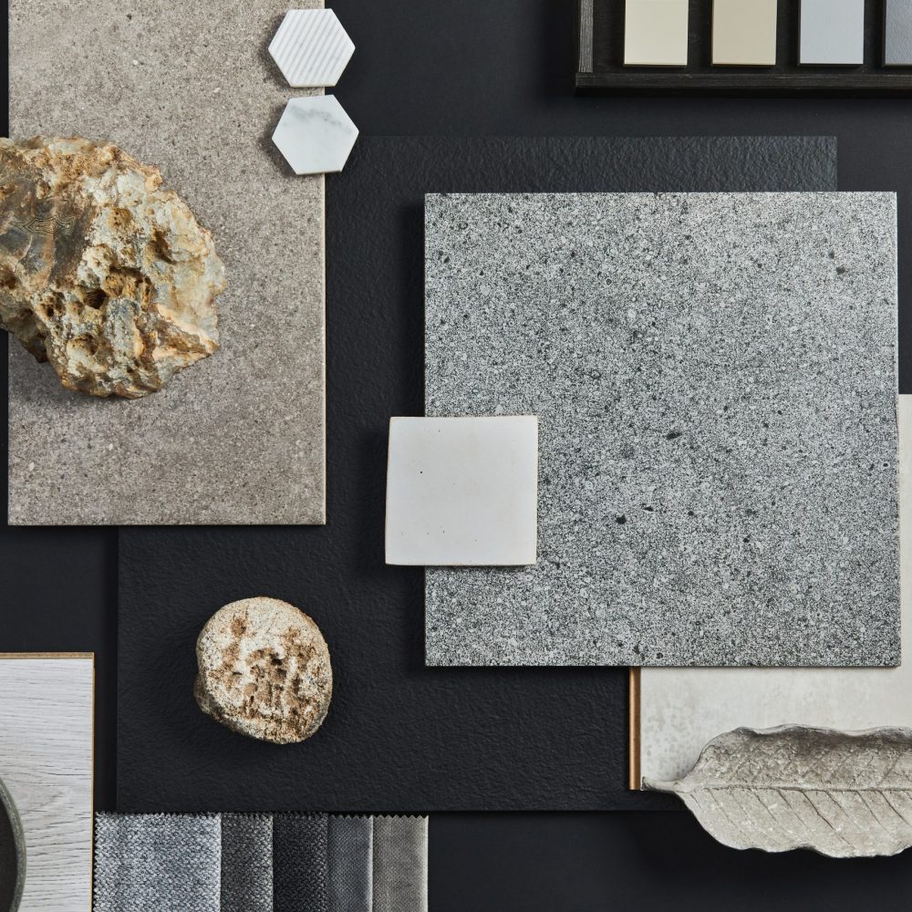 Flat lay composition of creative black architect moodboard with samples of building, textile and natural materials and personal accessories. Top view, black backgroung, template.