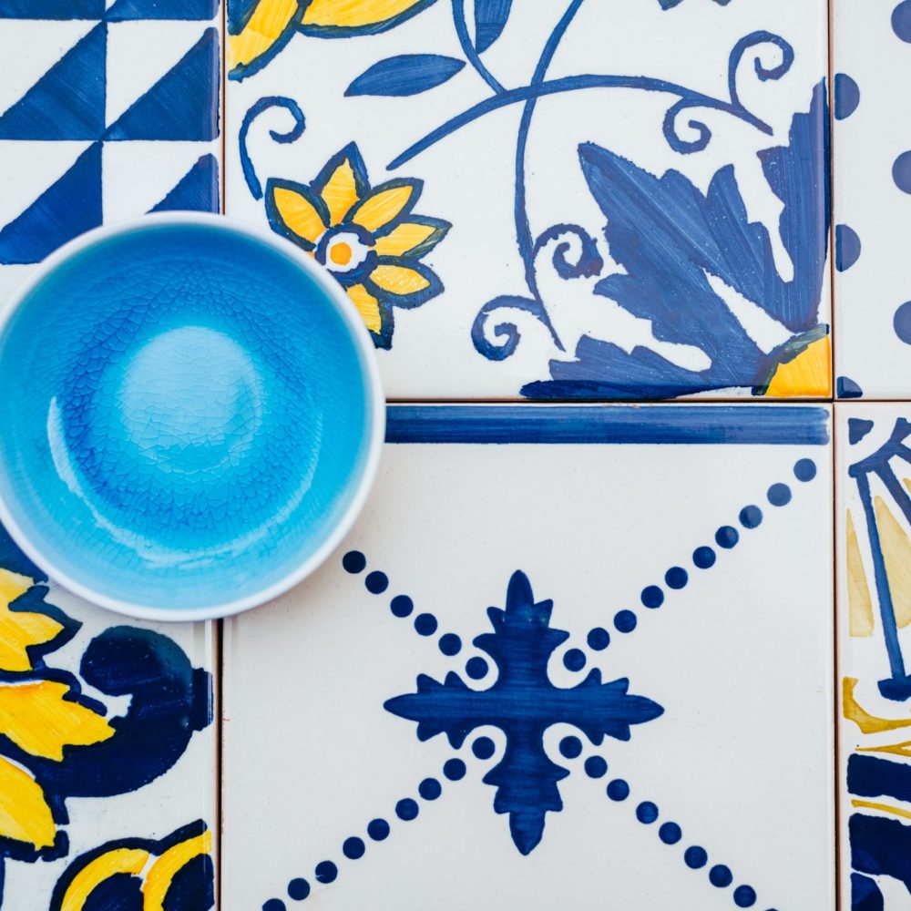 Ceramic Empty Blue Plate on Tile Background, Top View, Copy Space, Traditional Portuguese tiles Azulejo